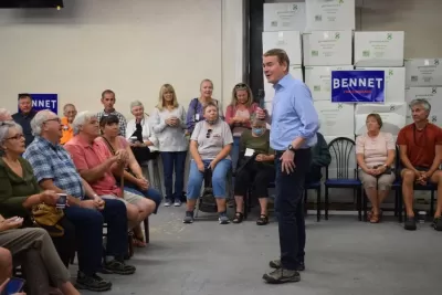 U.S. Sen. Michael Bennet addresses a crowd Wednesday at The Coffee Trader's downtown warehouse location